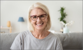 Patient putting on clear aligner in treatment room