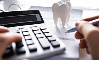 Patient in Massapequa Park calculating root canal cost