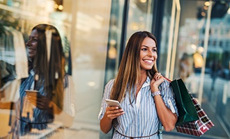 Woman smiling while shopping outside