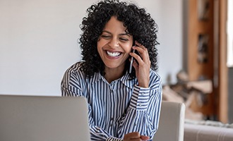 Woman smiling while talking on phone